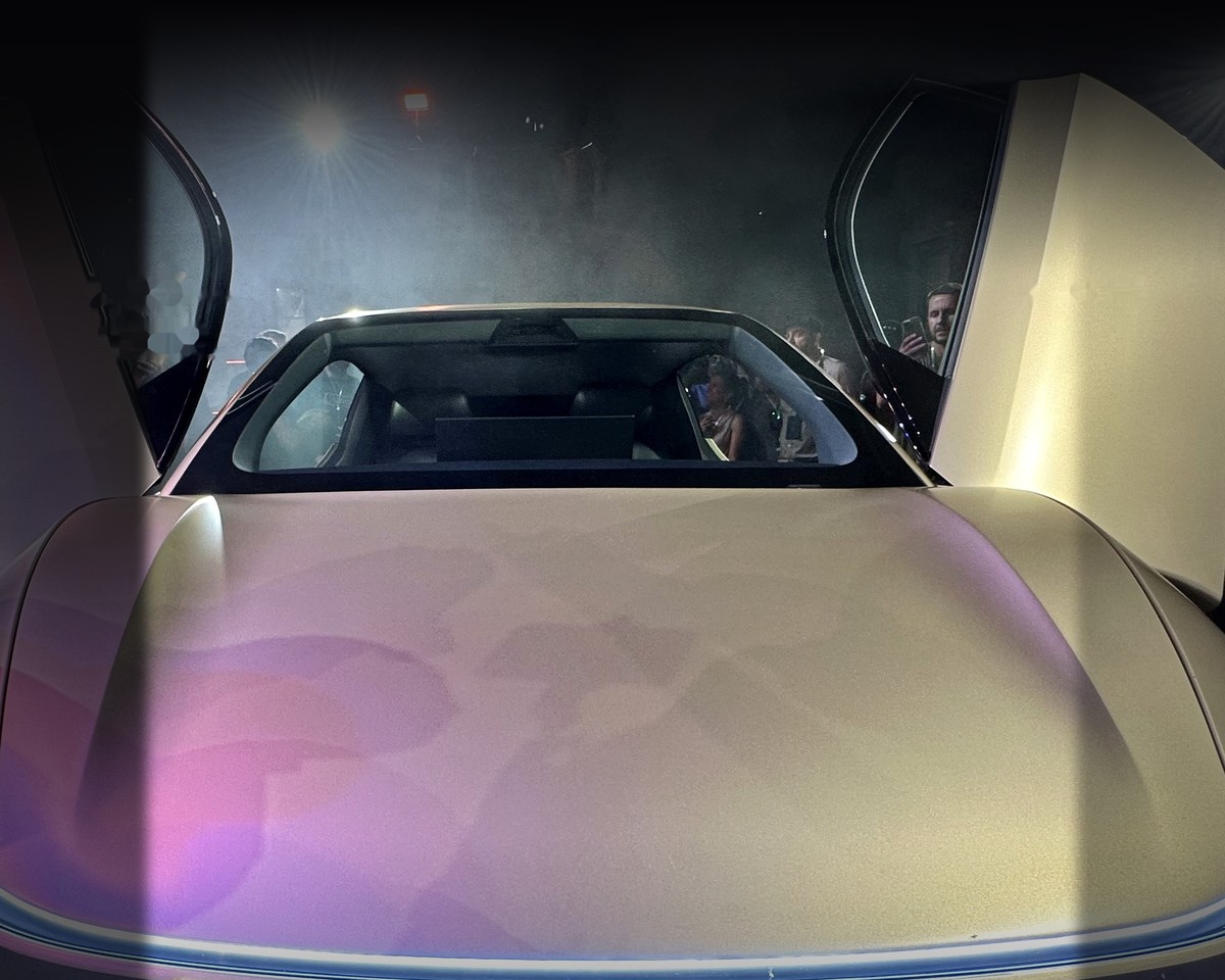 Tesla Cybercab with gull-wing doors open at the Austin launch event